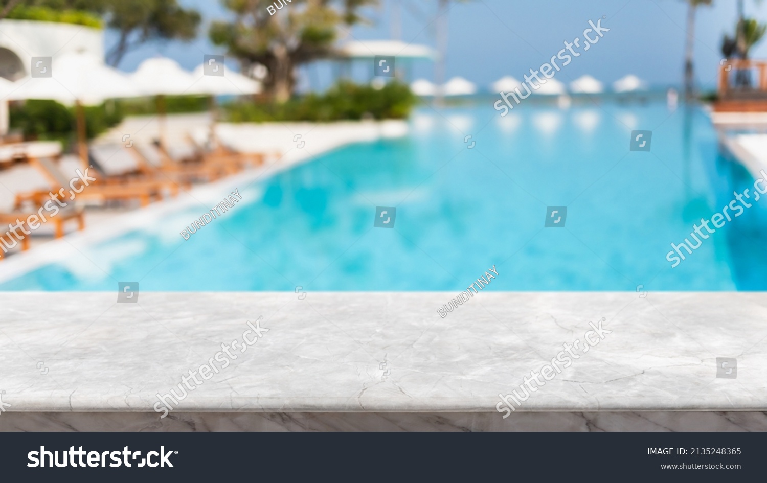 Empty white marble stone table top and blurred swimming pool in tropical resort in summer banner background - can used for display or montage your products. #2135248365