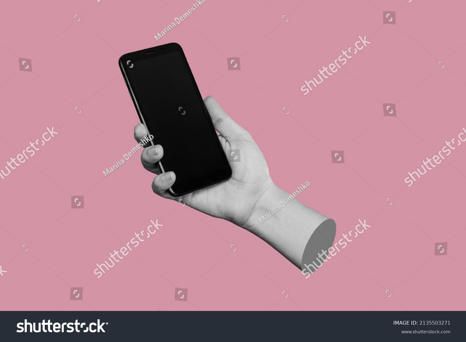 Mobile phone with black screen in female hand isolated on a pink color background. Blank with an empty copy space for the text. Trendy collage in magazine urban style. Contemporary art. Modern design #2135503271
