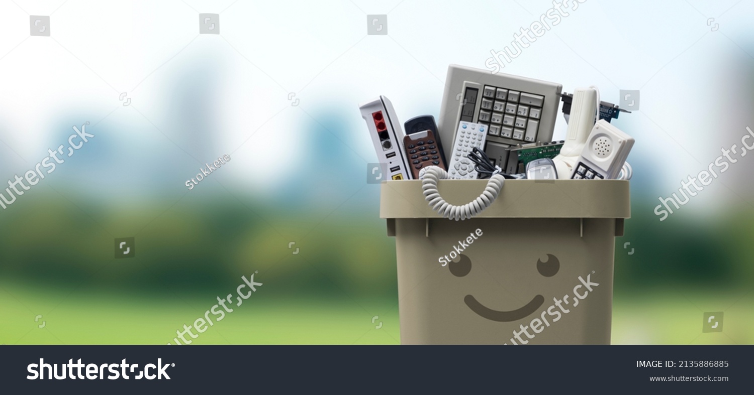 Recycling bin full of electronic waste, smiling cute character #2135886885