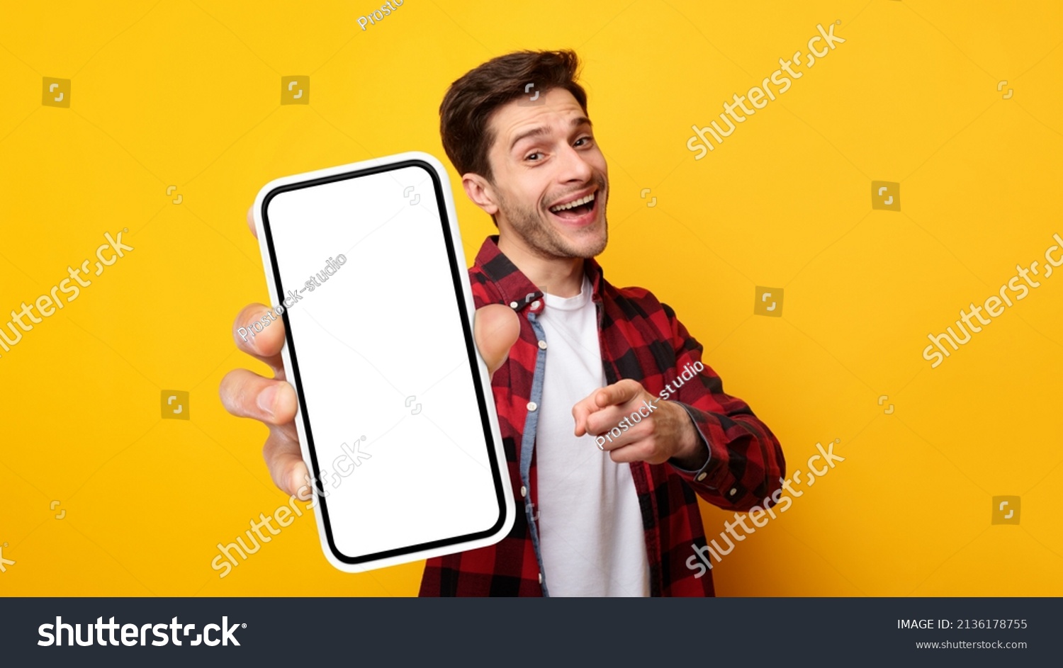 Cheerful Emotional Man Holding Big Blank Cell Phone In Hand Showing White Screen To Camera Pointing At You, Happy Millennial Guy Recommending New Application Or Mobile Website, Mockup Banner Collage #2136178755