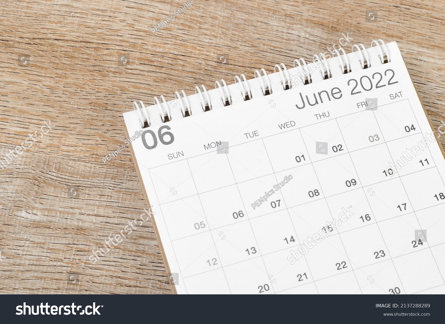 The June 2022 desk calendar on wooden background. #2137288289