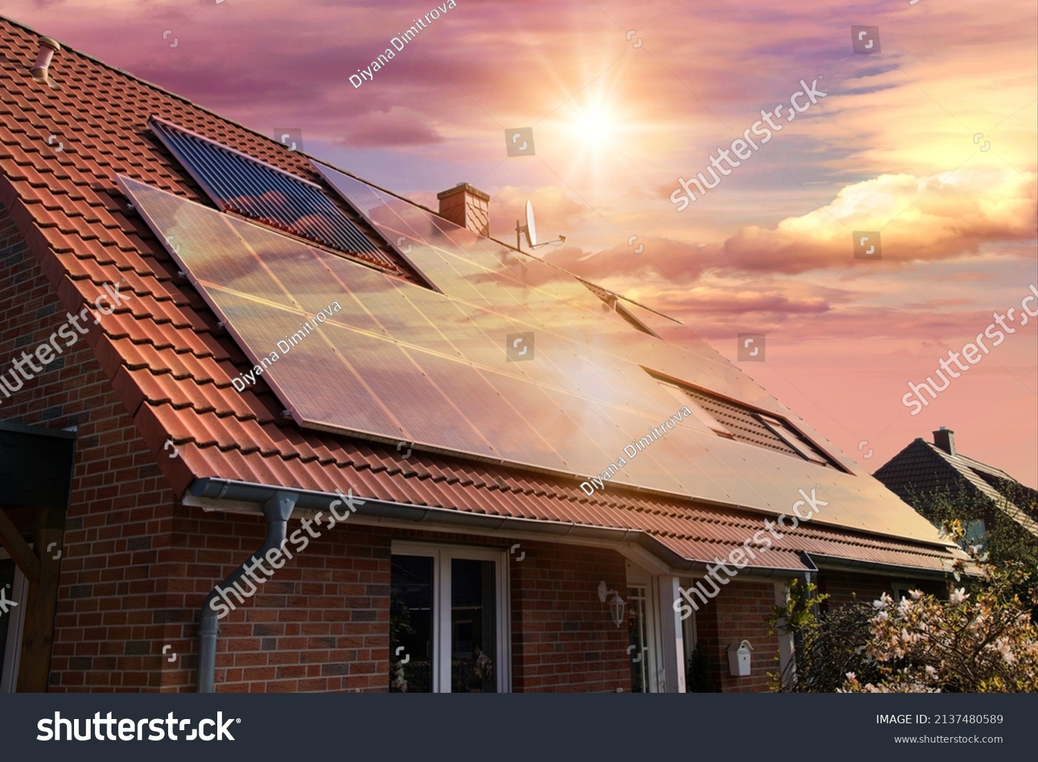 Photo collage of solar panels, photovoltaics on the red roof of a house and a beautiful sky with the setting sun. Alternative electricity source. Concept of sustainable resources #2137480589