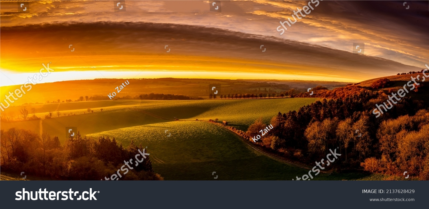 Panorama of a beautiful sunrise over the valley. Beautiful valley panorama at dawn. Sunrise over beautiful valley panoramic landscape #2137628429