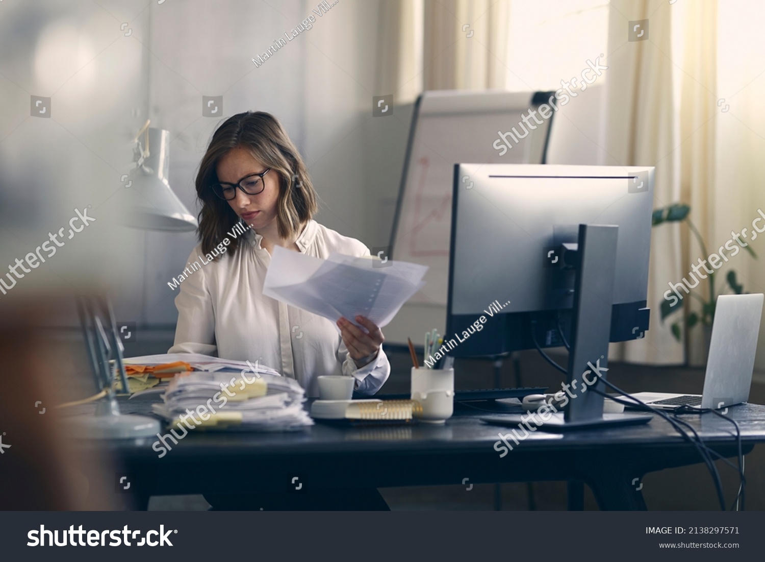 Beautiful young business woman sitting concentrated at her work in front of her office computer. #2138297571