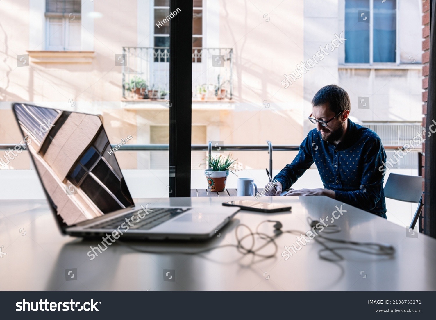 Man working at home and writing down his plan of action #2138733271