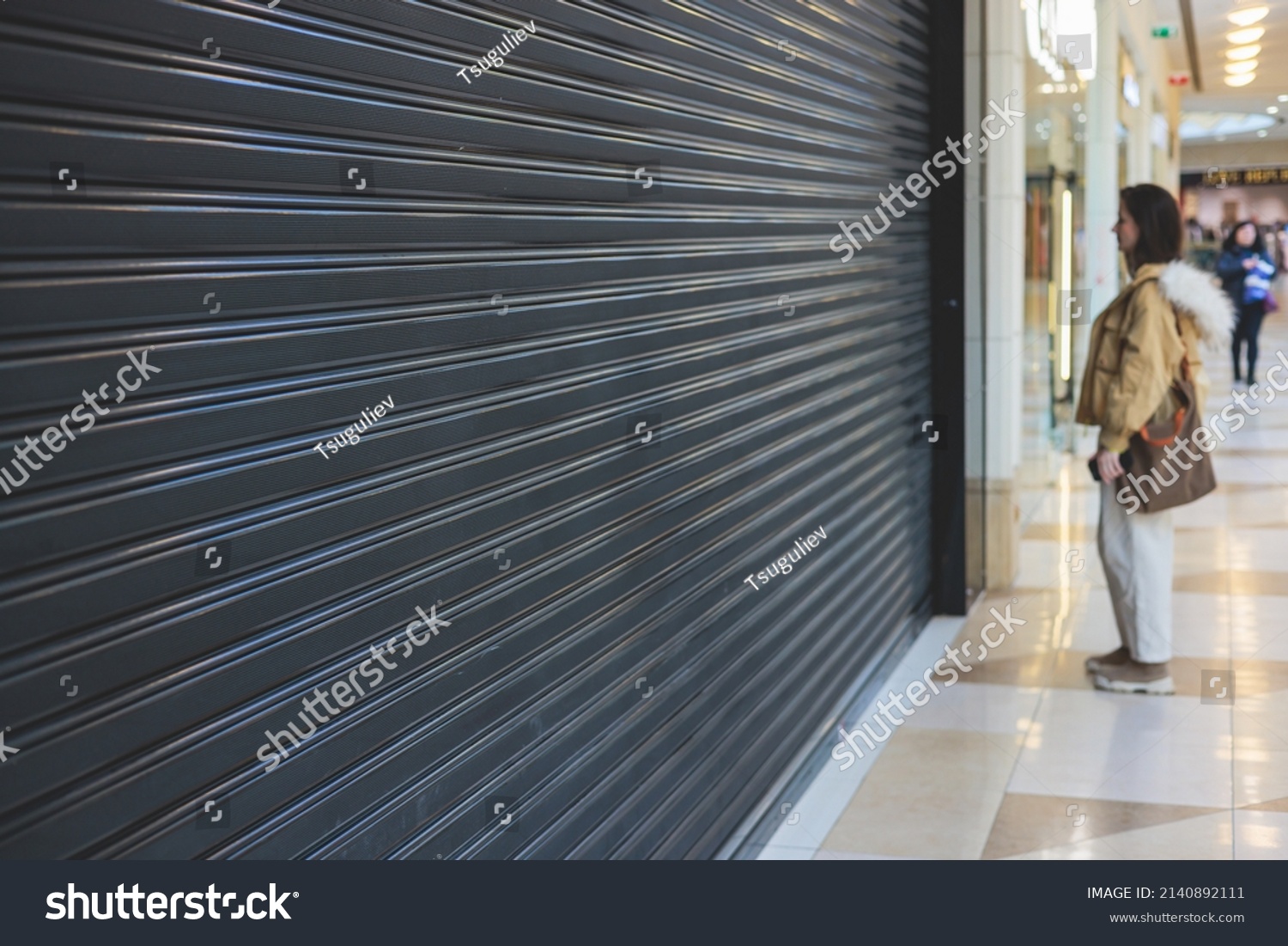 Stores show case in shopping mall closed due to sanctions, boycott and embargo, mass market cloth shops work stoppage with closed storefronts, retail business suspension and brands leaving market #2140892111
