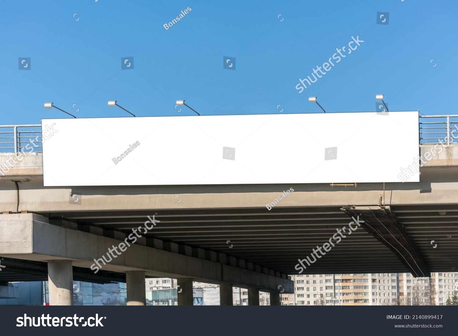 Long white empty signboard hanging on concrete urban bridge for commercial information and advertise message #2140899417