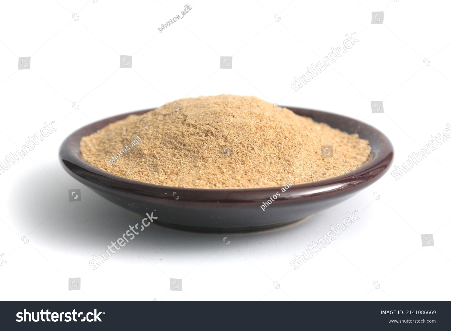 A plate with talkan (coarse flour from fried barley or wheat) on a white background #2141086669