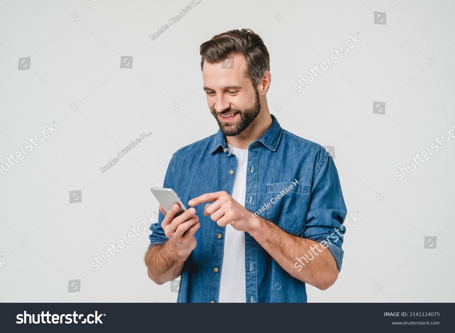 Happy caucasian young man using smart phone cellphone for calls, social media, mobile application online isolated in white background #2141124075