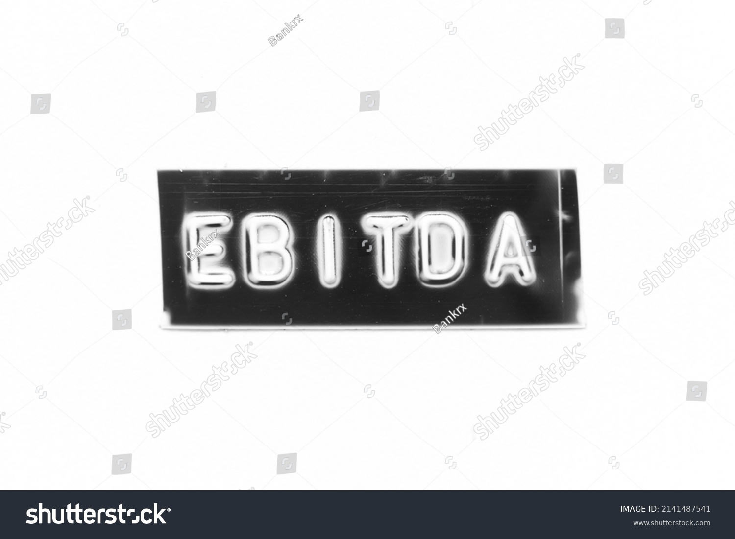 Black color banner that have embossed letter with word EBITDA (abbreviation of earnings before interest, taxes, depreciation and amortization) on white paper background #2141487541