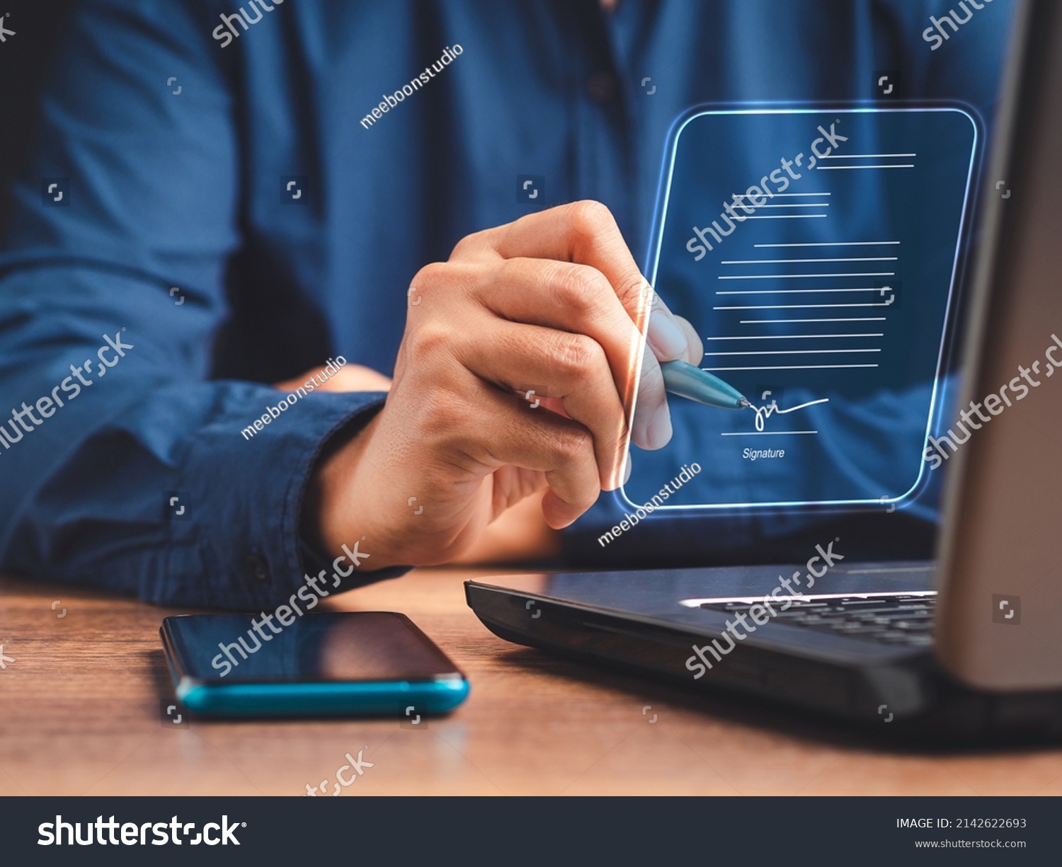 Electronic signature and paperless office concept. A businessman uses a pen to sign electronic documents on digital documents on a virtual screen. E-signing. Technology and document management #2142622693