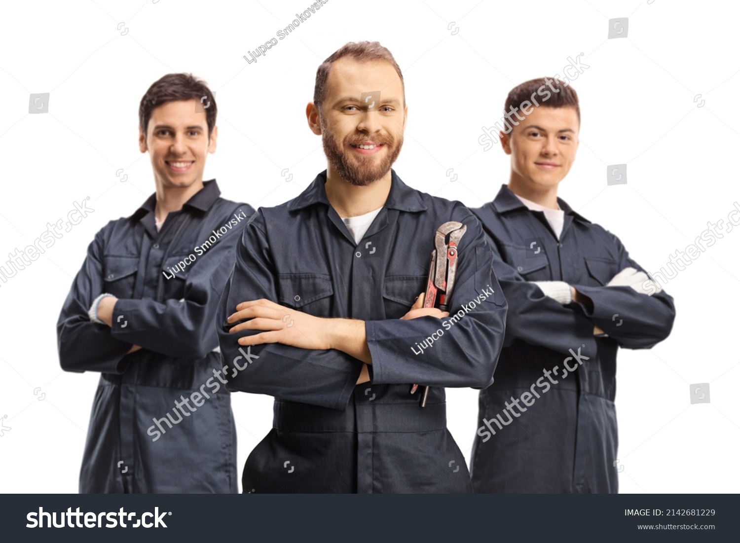 Team of plumbers in uniforms looking at camera isolated on white background #2142681229