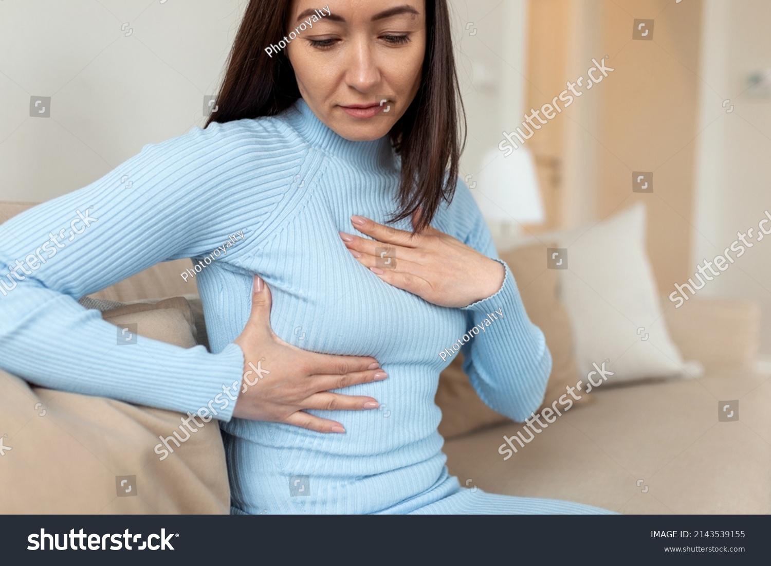Asian Woman checking lumps on her breast for signs of cancer. woman is suffering from pain in the breast. BSE or Breast Self-Exam. Guidelines to check for breast cancer. #2143539155