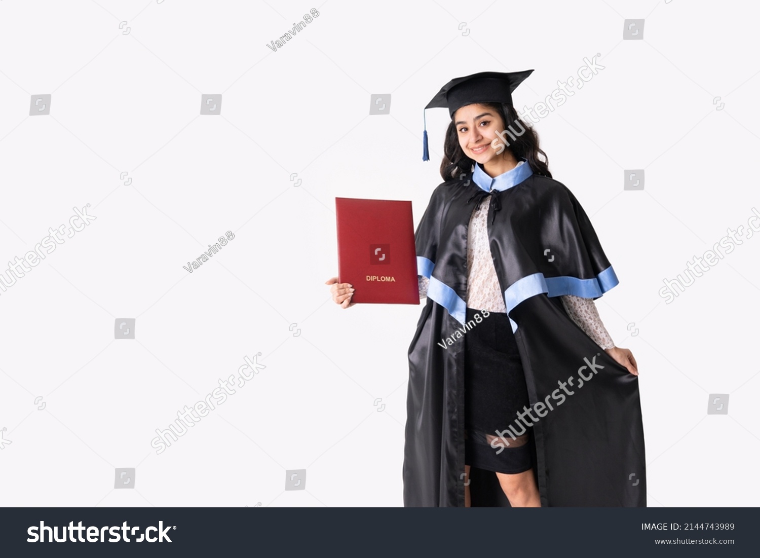 University graduate indian race woman wearing academic regalia and red diploma isolated. #2144743989