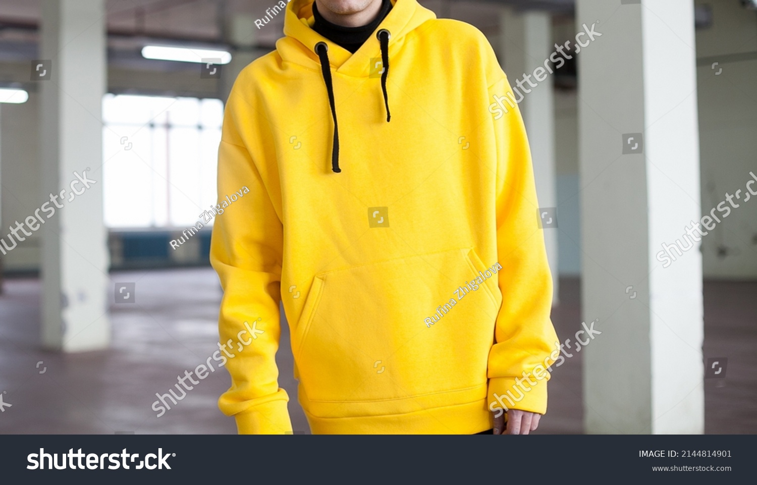 poster close up details of oversized yellow hoodie  at male.fashion and wear concept. trendн warm oversize wear at man.space for text and logo.close up details of oversize wear.horizontal banner wear #2144814901