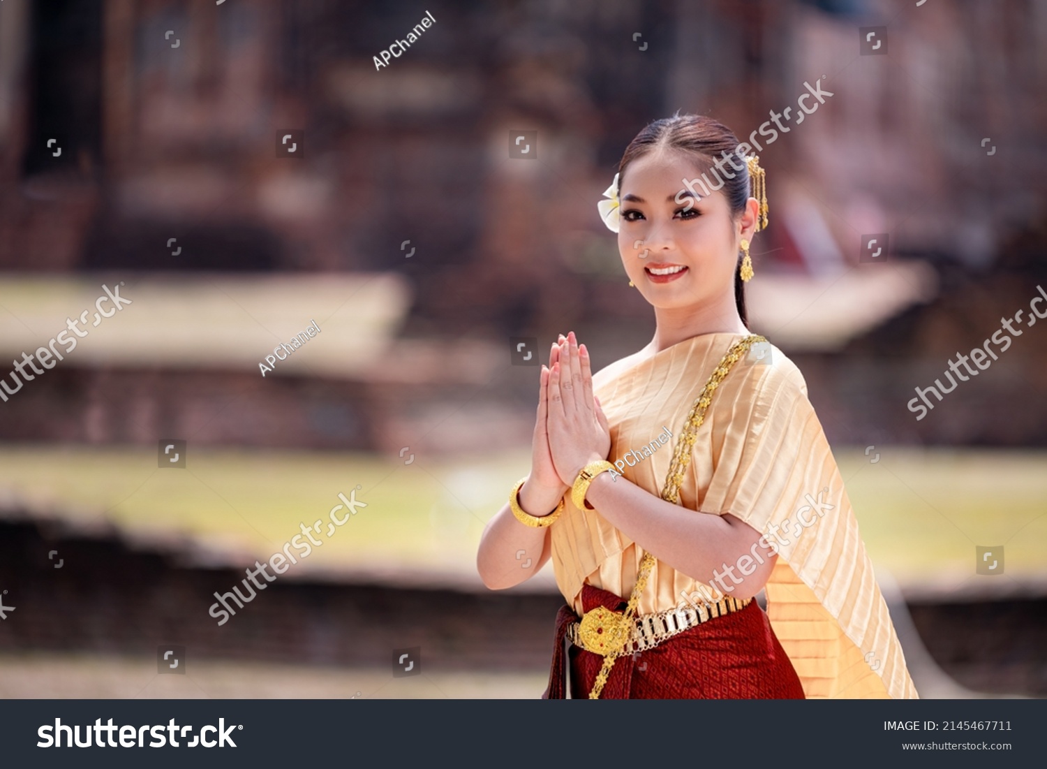 Portrait Asian model posing to pay respect with smiling wearing Thai dress traditional costume greeting  happy new year thailand songkran festival. #2145467711