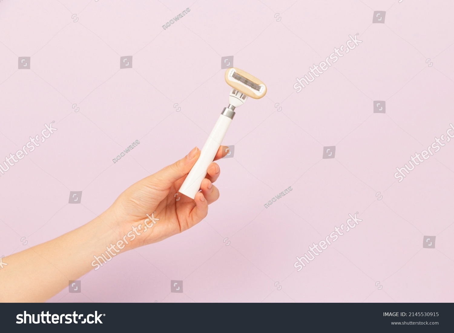 girl holding razor in hand on pink background #2145530915