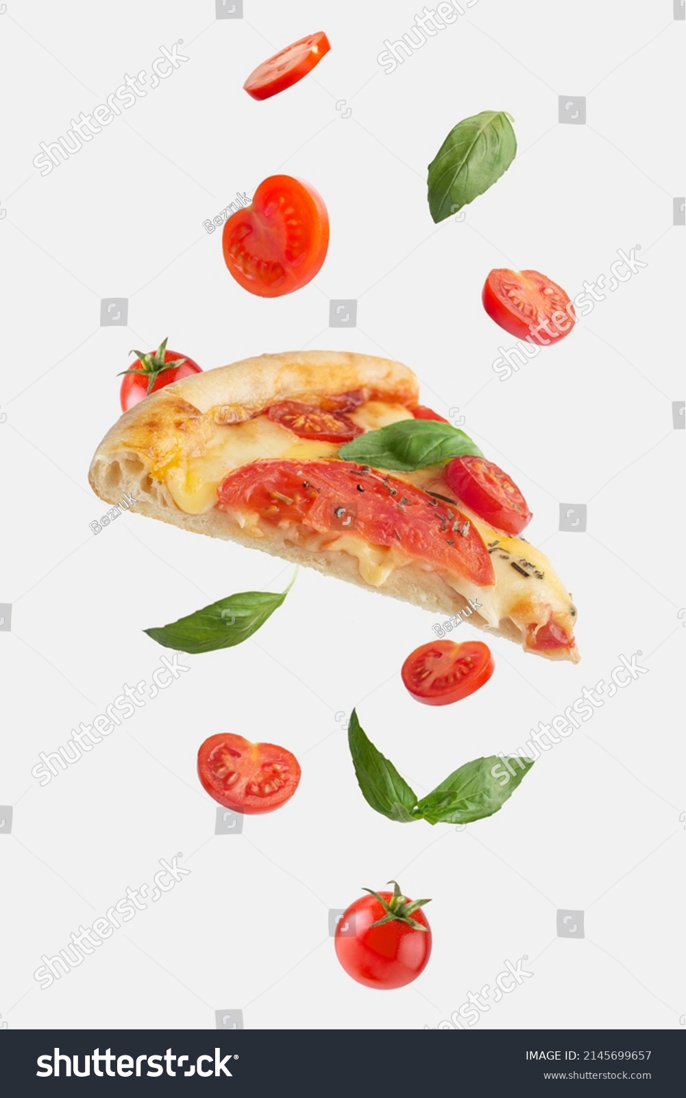 flying slice of margherita pizza with tomatoes and basil #2145699657