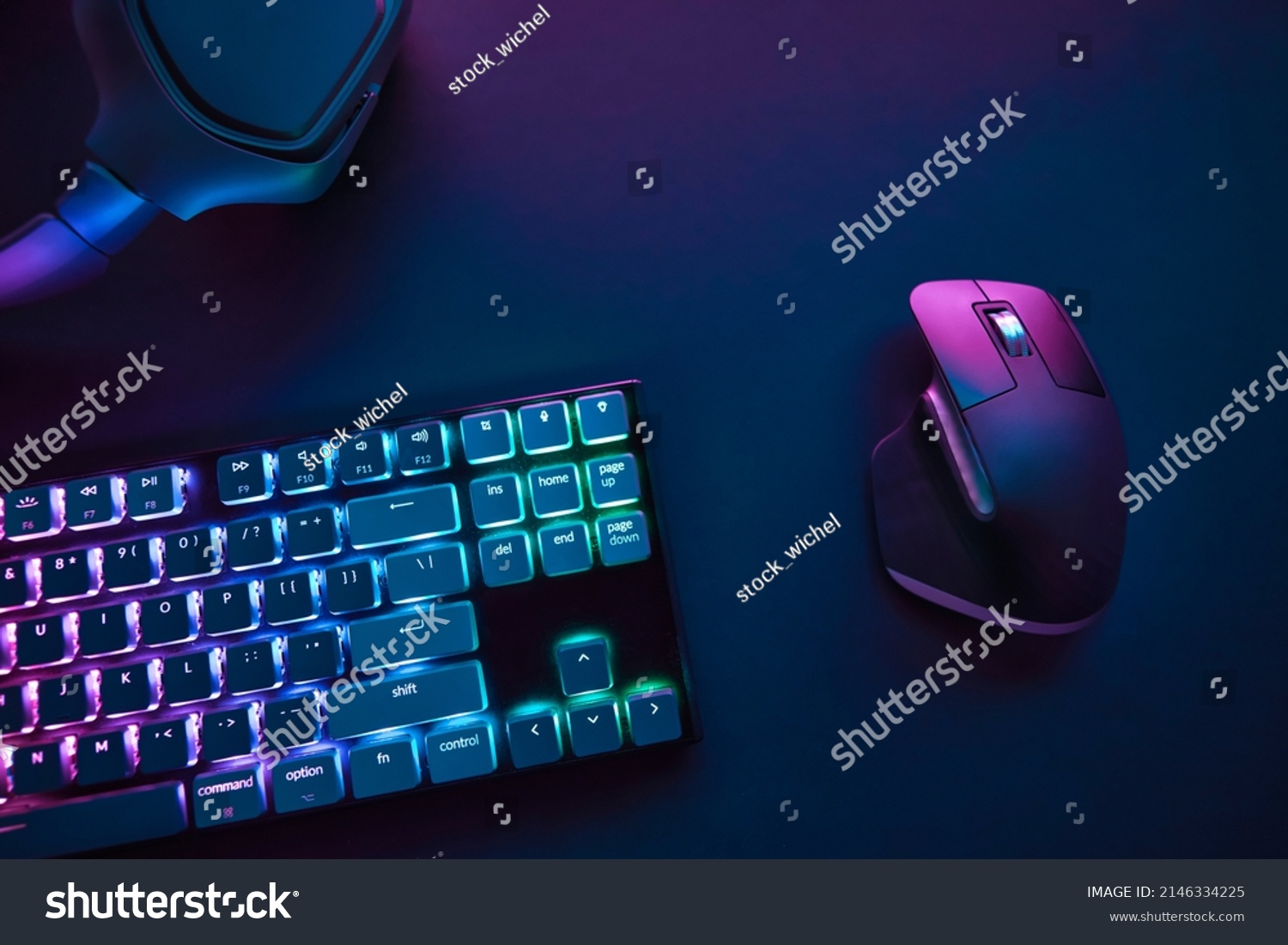 View of pastel neon color backlighted computer keyboard and mouse from above. Professional computer game playing, esport business and online world concept. #2146334225