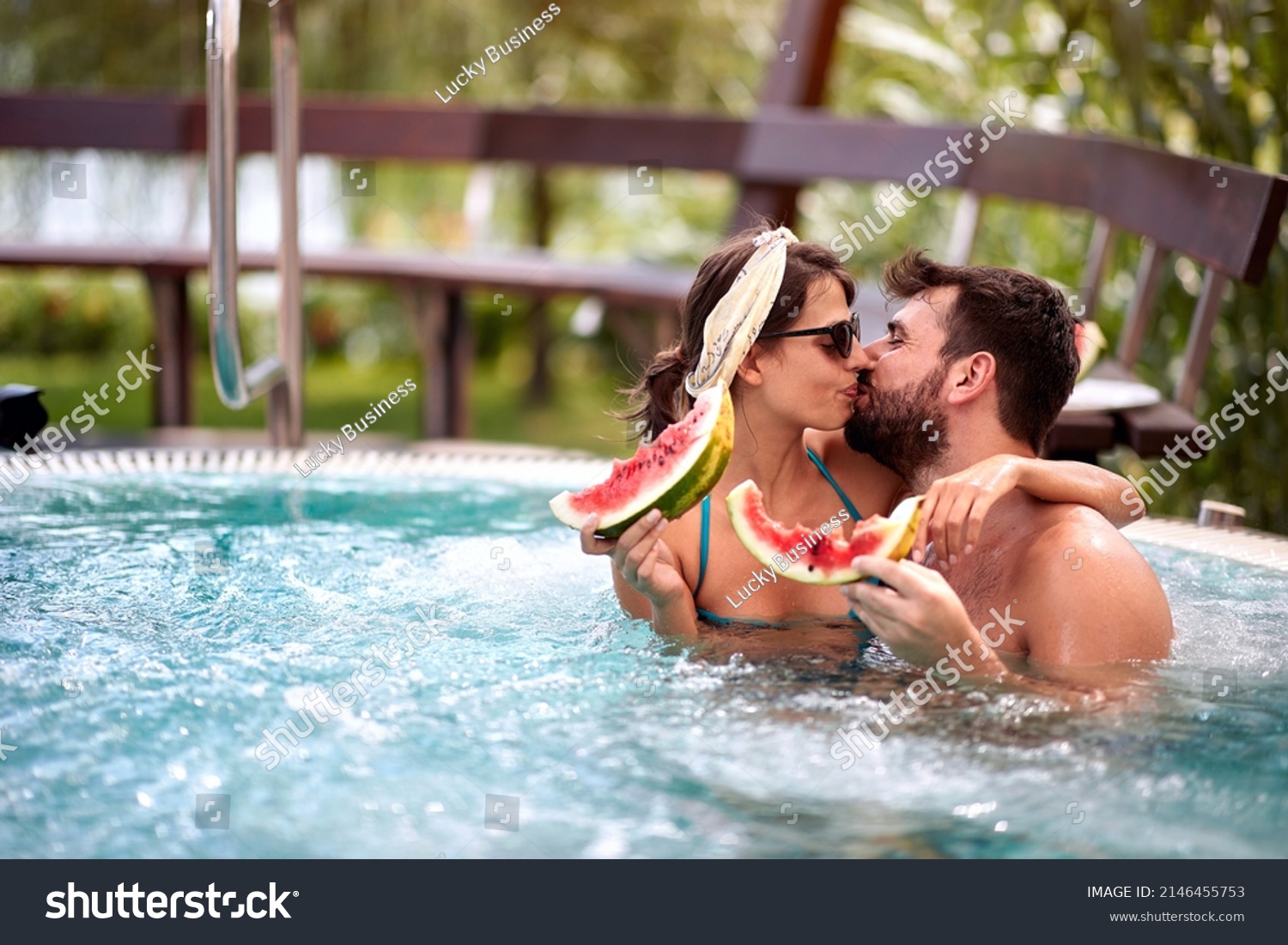 Couple in love hugging and kissing in pool  #2146455753