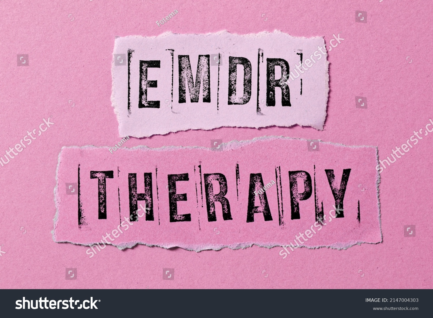 Eye Movement Desensitization and Reprocessing psychotherapy treatment concept. Letters EMDR and therapy written on torn paper. #2147004303