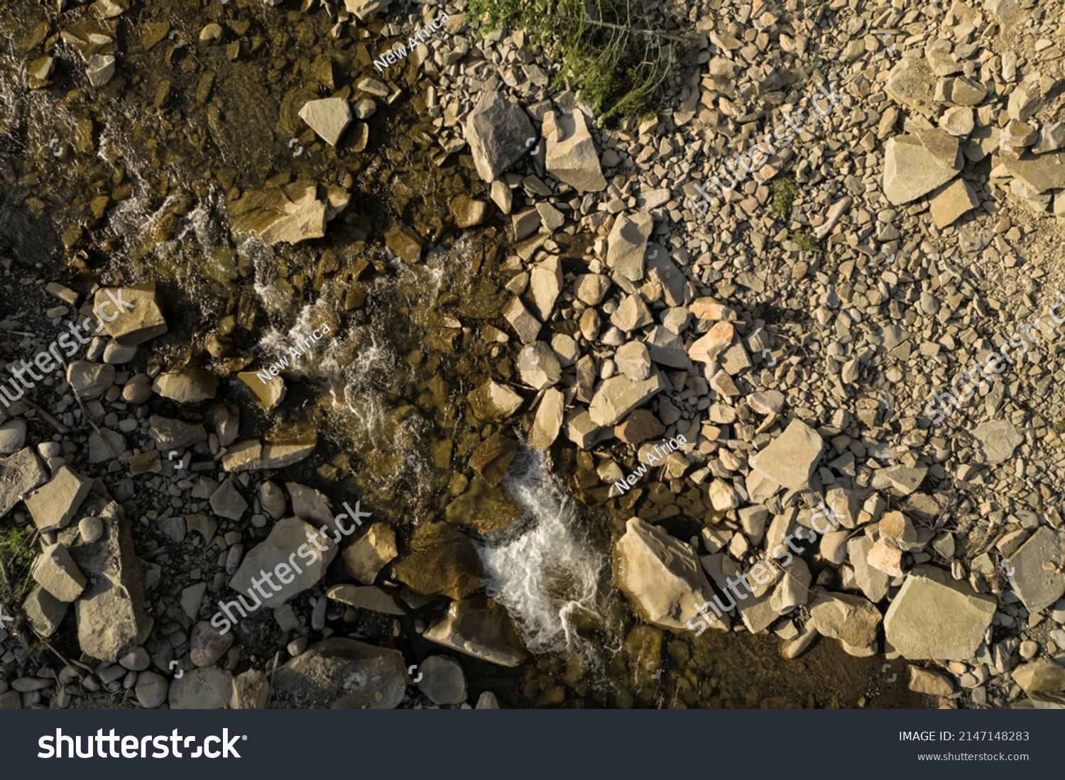 Aerial view of rocky terrain with creek. Drone photography #2147148283