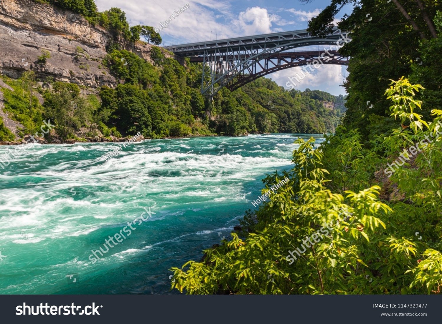 Rapids in the Niagara River near the so called whirlpool at the nagar falls. The river winds through the high gorges with immense speed. Niagara Falls is a must-see for tourists in Canada #2147329477