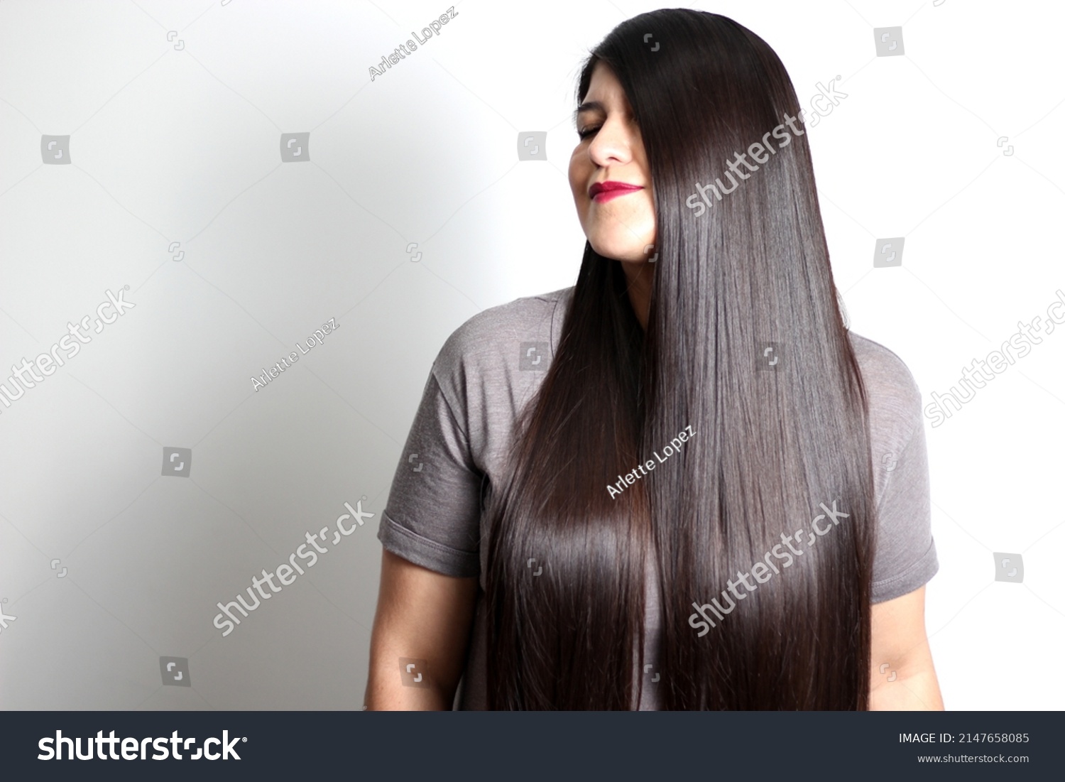 Overweight Latin young adult woman shows how silky and shiny her black hair is, very long, straight, very happy and proud of the beautiful hair with a beautiful haircut
 #2147658085
