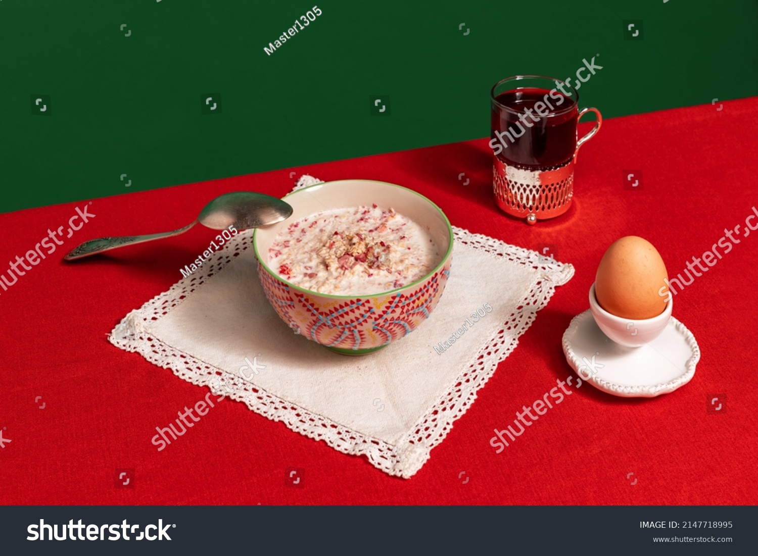 English traditions. Served breakfast table. Food pop art photography. Tea pot, grapefruit and porridge on red tablecloth over green background. Retro 80s, 70s style. Complementary colors, #2147718995