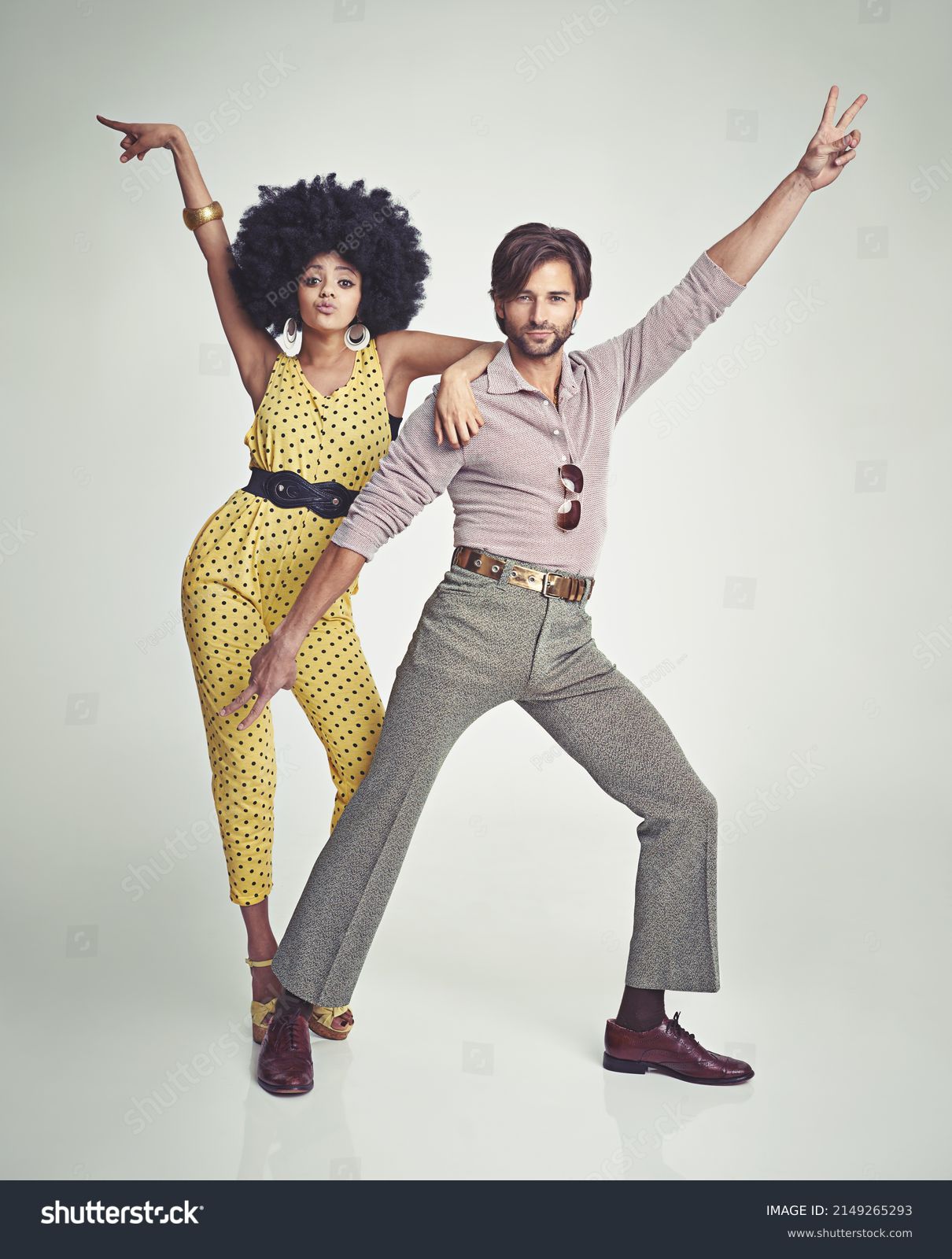 Lets dance. An attractive young couple standing together in retro 70s clothing. #2149265293