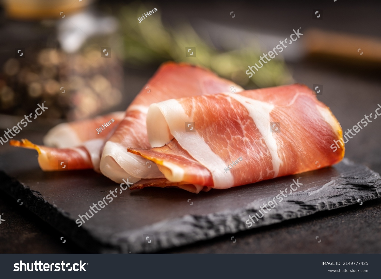 Sliced schwarzwald ham. Dried prosciutto ham on a cutting board. #2149777425