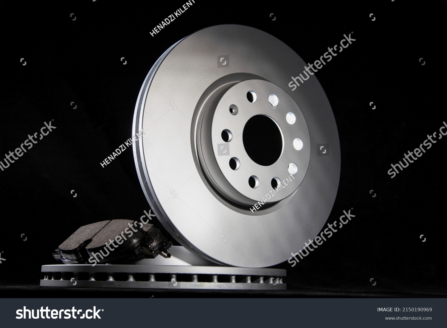 New brake pads and brake discs on a black background. Auto Parts Braking System #2150190969