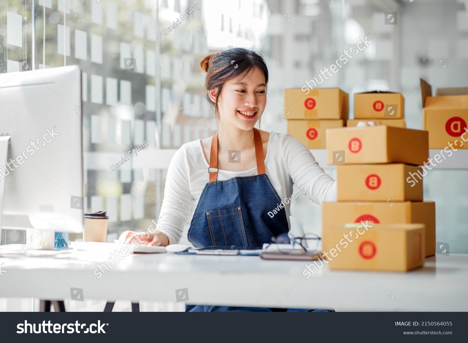 SME entrepreneur Small business entrepreneurs Online selling ideas,Happy Young Asian business owner work on computer and a boxs at home,delivery SME procurement package box deliver to customers,  #2150564055