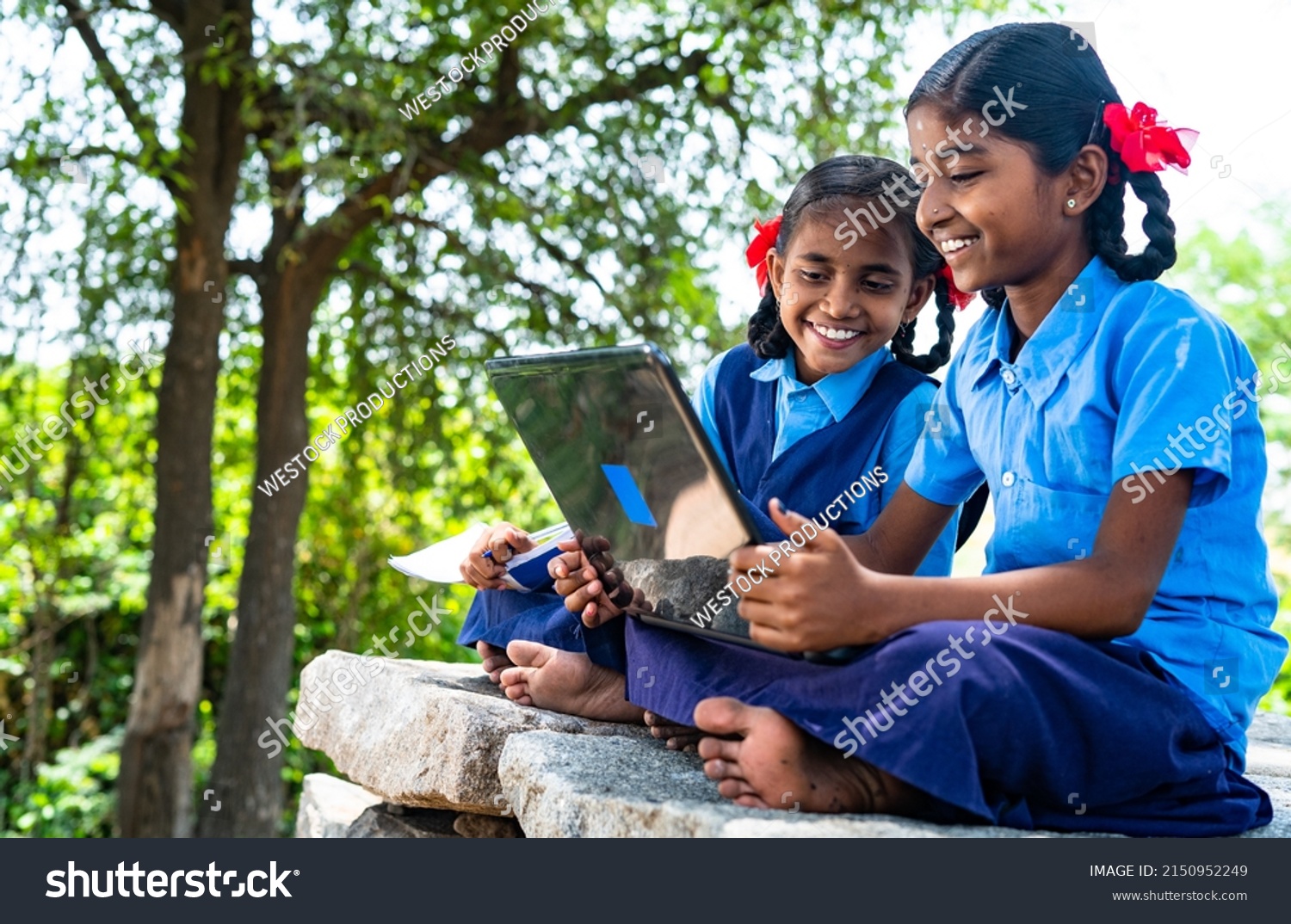handheld shot of Village school girl kids seriously busy working on laptop - concept of education, technology and knowledge #2150952249