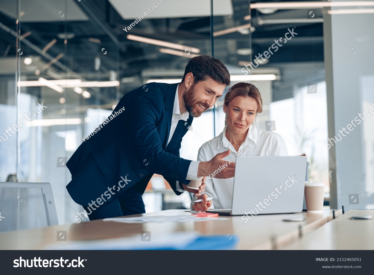 Female boss discussing online project with employee showing presentation to experienced team leader #2152465051