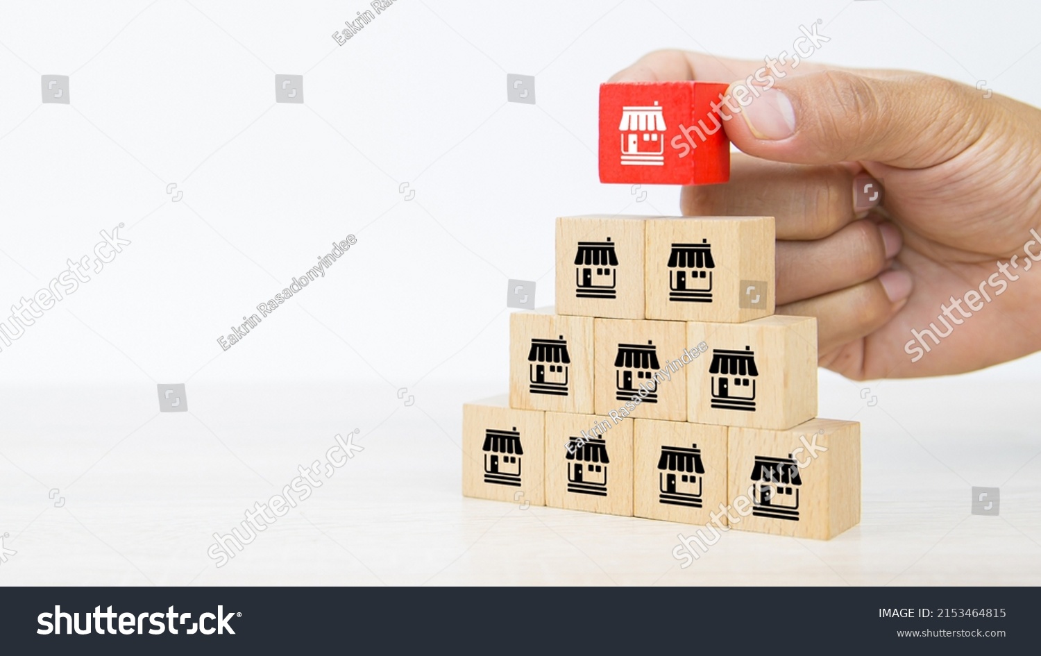Franchise, Close-up hand choose cube wooden toy block stack with franchises business store icon for franchising business marketing plan to growth and branch expansion and banking loan. #2153464815