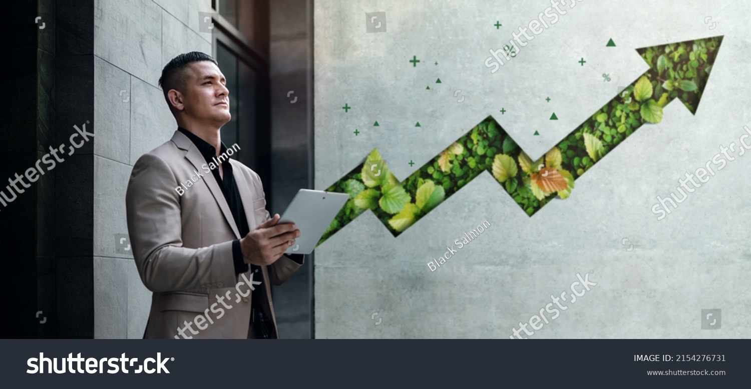 ESG Concepts. Environmental, Social and Corporate Governance. Businessman Working on Tablet. Sustainable Resources. Environmental and Business Growth Together. Blurred Green Leaf Arrow as background #2154276731