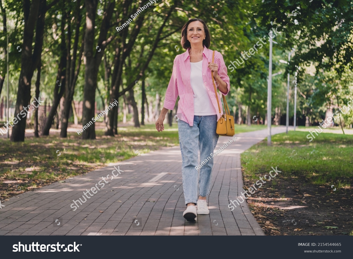 Photo of pretty adorable lady pensioner wear pink shirt walking smiling outdoors countryside garden #2154544665