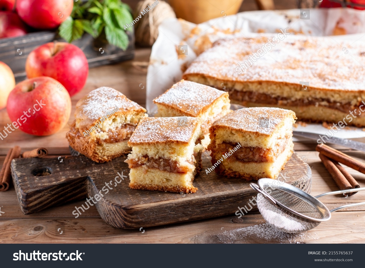 Sponge cake with apples on a wooden board on the table. Homemade pie #2155765637