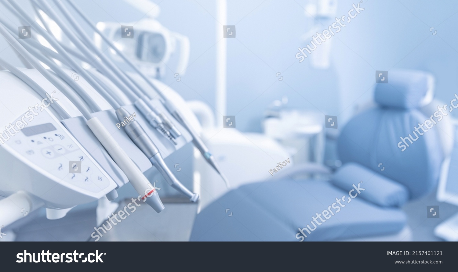 Banner dentists room office. Closeup different dental instruments and tools, blue toning. #2157401121