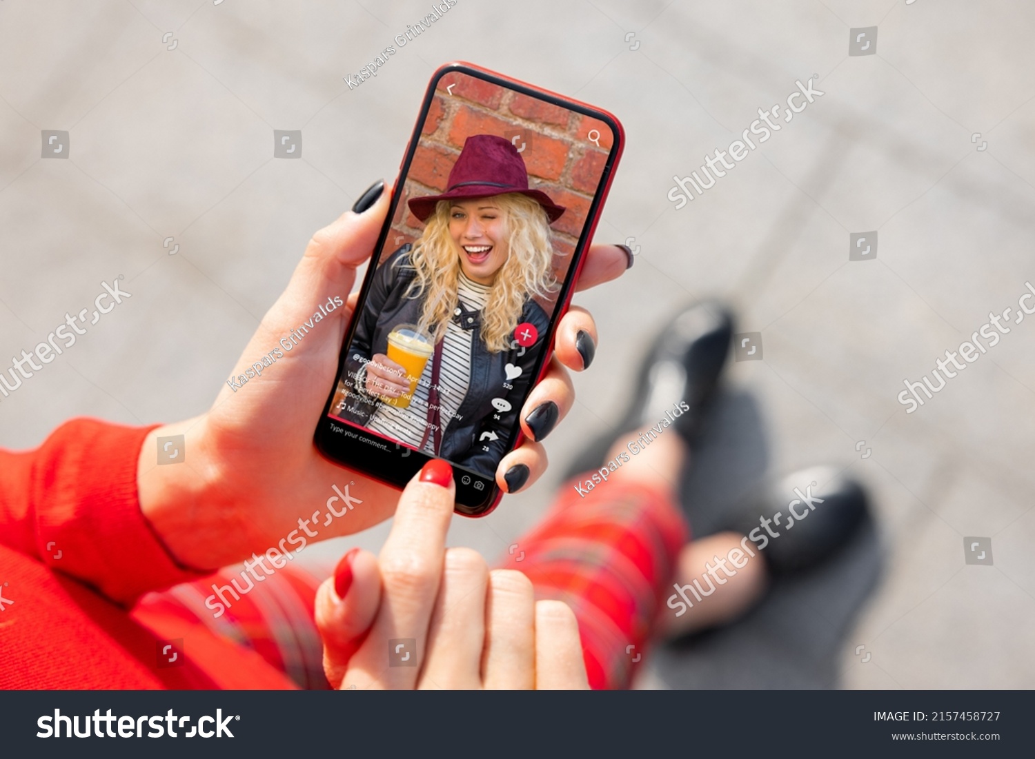 Woman viewing social media content on mobile phone #2157458727
