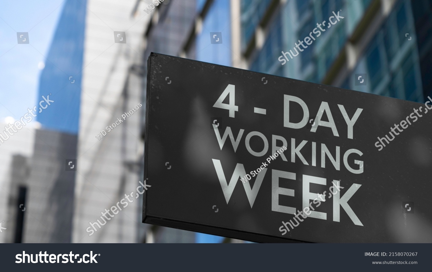 4 - Day working week on a black city-center sign in front of a modern office building	 #2158070267