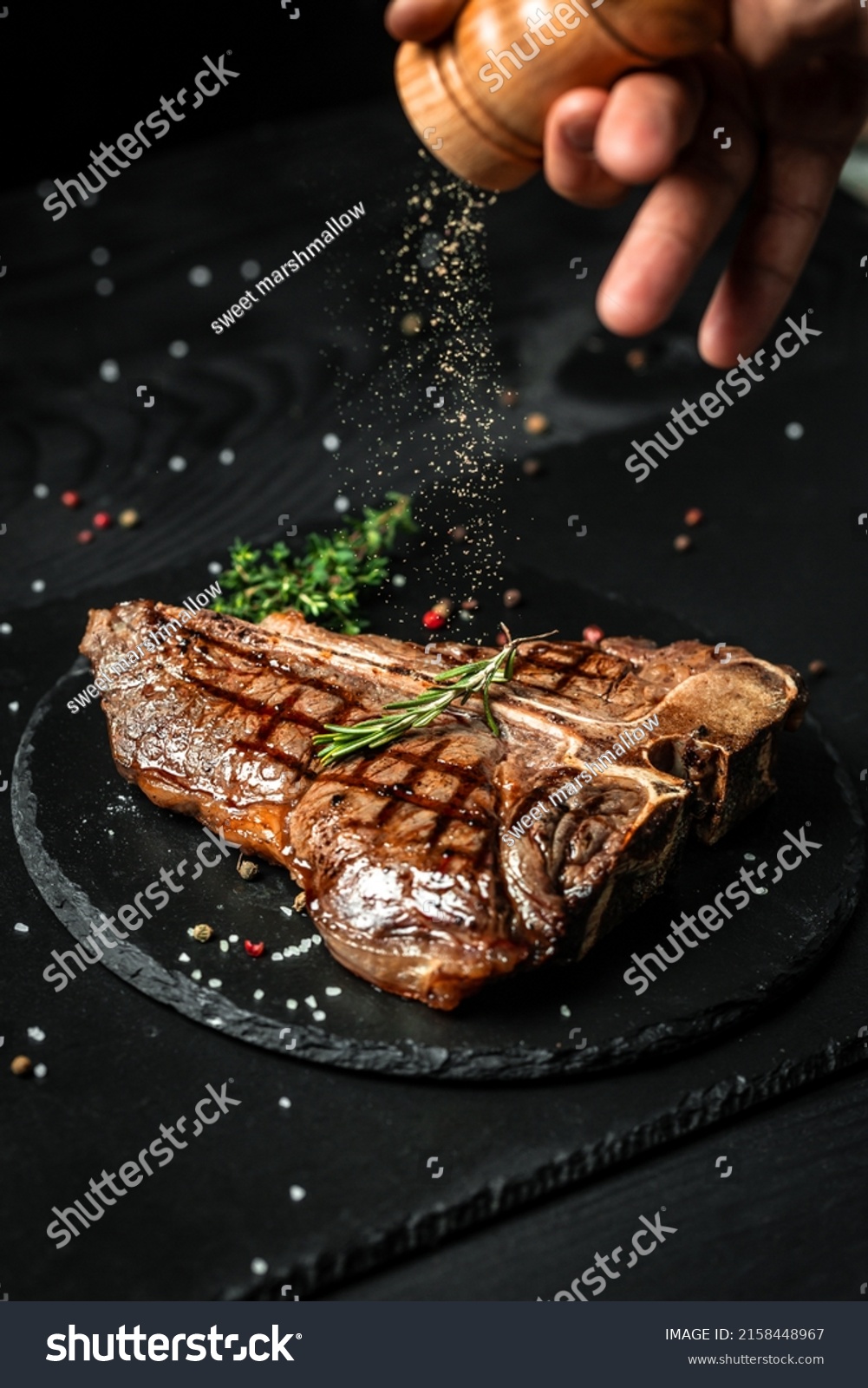 Chef hands cooking meat steak and adding seasoning in a freeze motion. Fresh raw Prime Black Angus beef rump steak. banner, menu recipe. #2158448967
