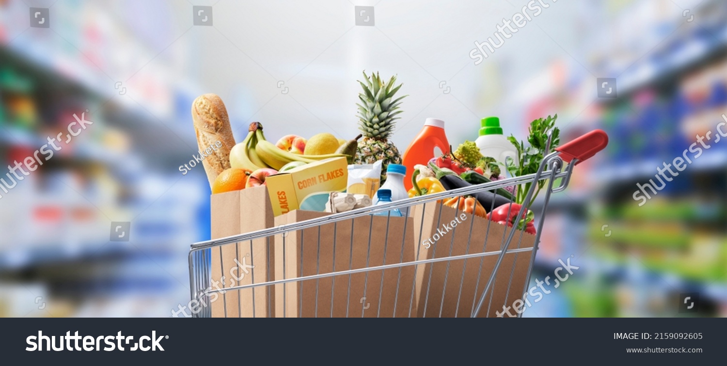 Shopping cart full of groceries at the supermarket #2159092605