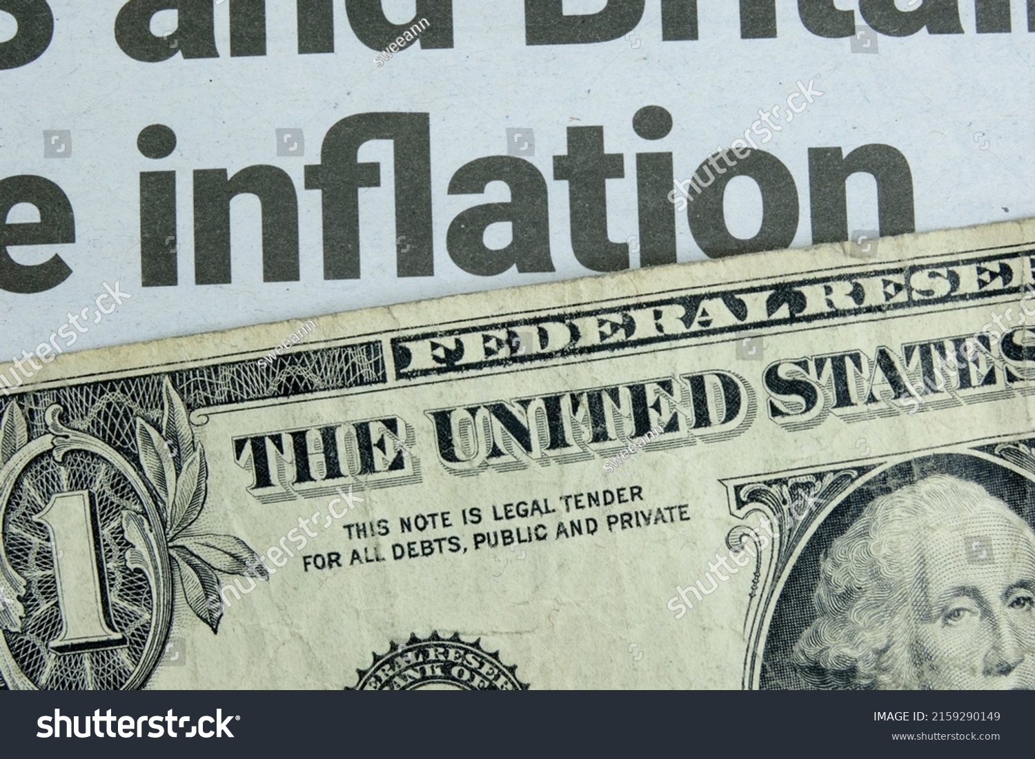 A US one dollar bill lying below a newspaper headline news on inflation. Concept for the dollar buying power amidst rising goods prices due to shortages and increasing demand. Closeup macro view. #2159290149