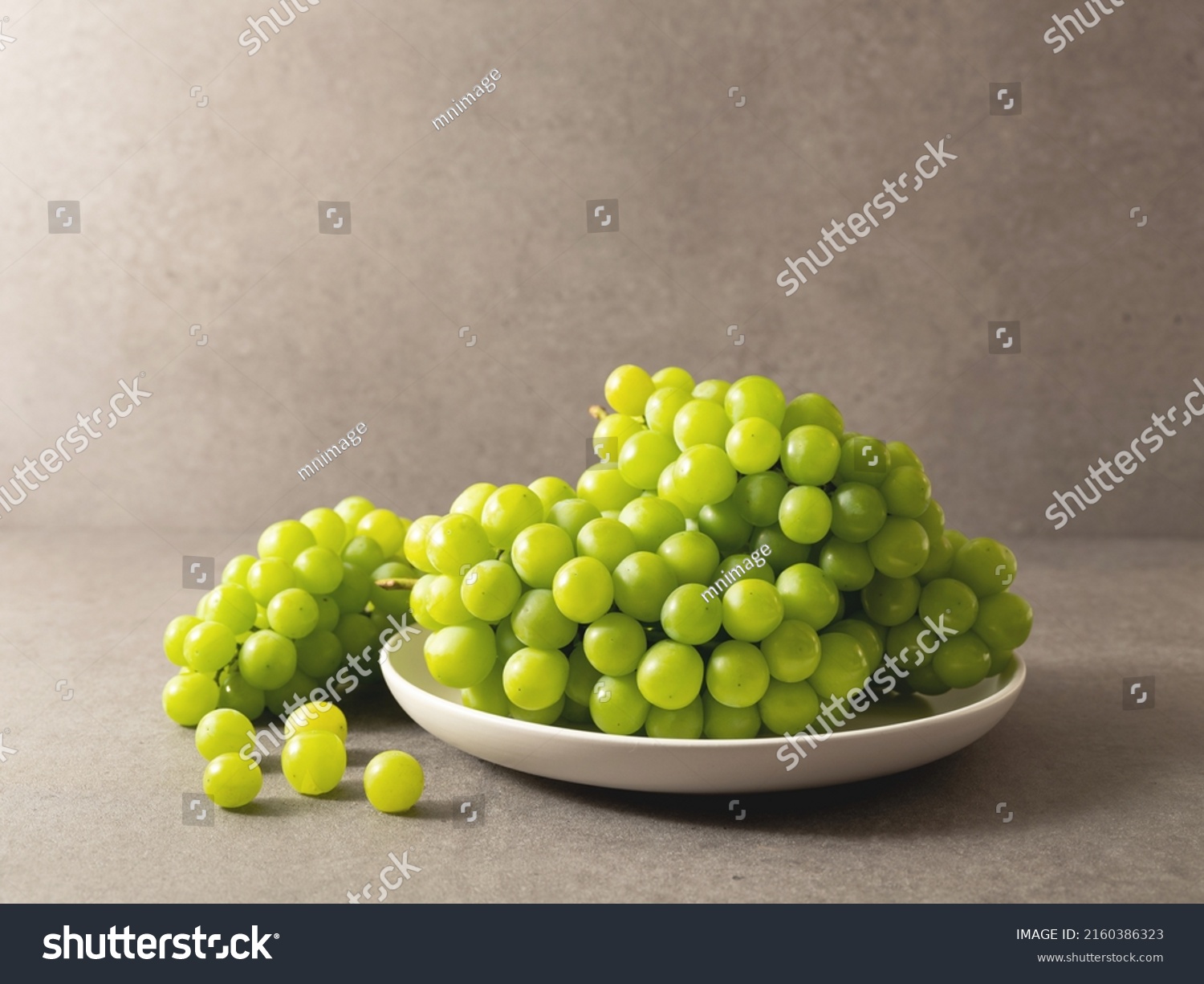green grapes on a plate	 #2160386323