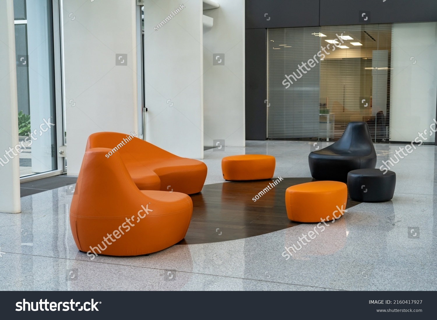 Empty hallway with orange modern chairs in office. Interior of modern entrance lobby in modern office building #2160417927