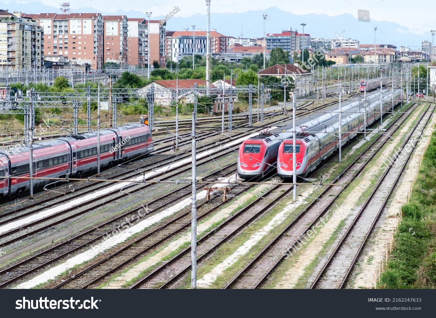 high-speed trains: two trains on tracks ready to travel and transport passengers for economic activities and tourism. Ideal for traveling on holidays, economic and green transport par excellence. #2162247633