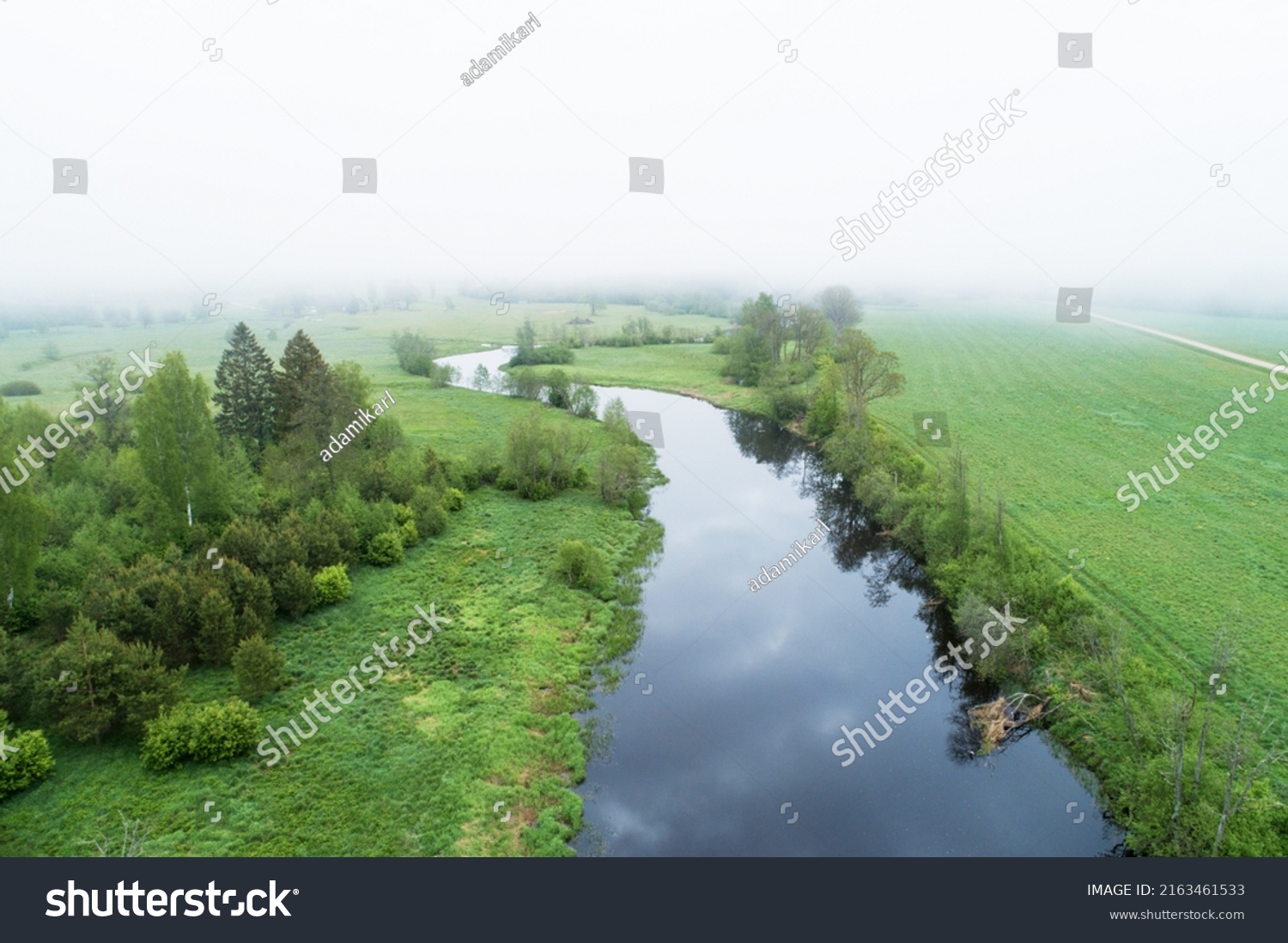 High angle view to a misty river landscape on a late spring morning in Estonia, Northern Europe #2163461533