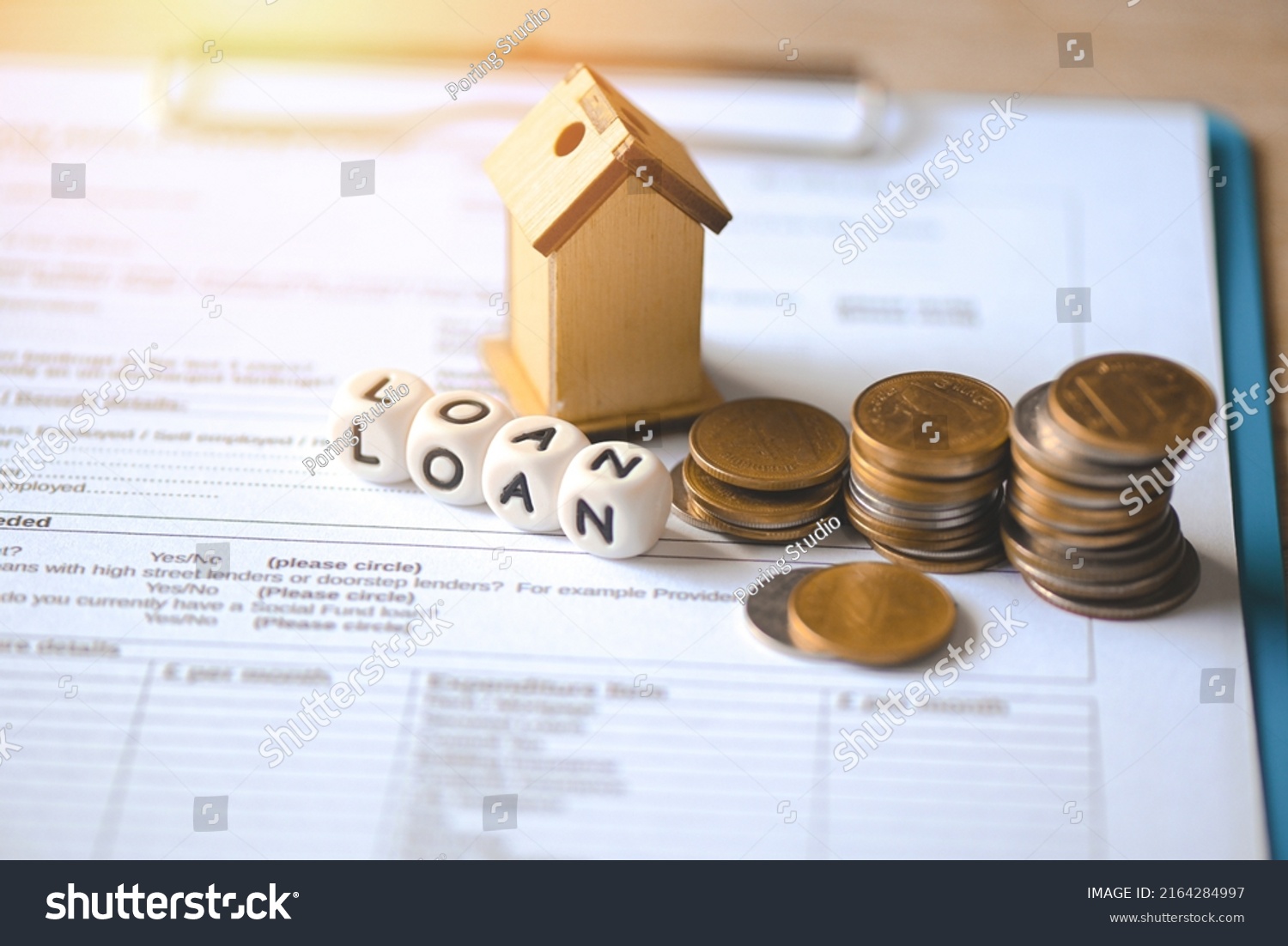 Home loan concept, Loan application form paper with money coin and loan house model on table, Loan business finance economy commercial real estate investments concept #2164284997